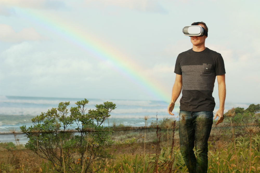 Man wearing a VR headset outdoors.